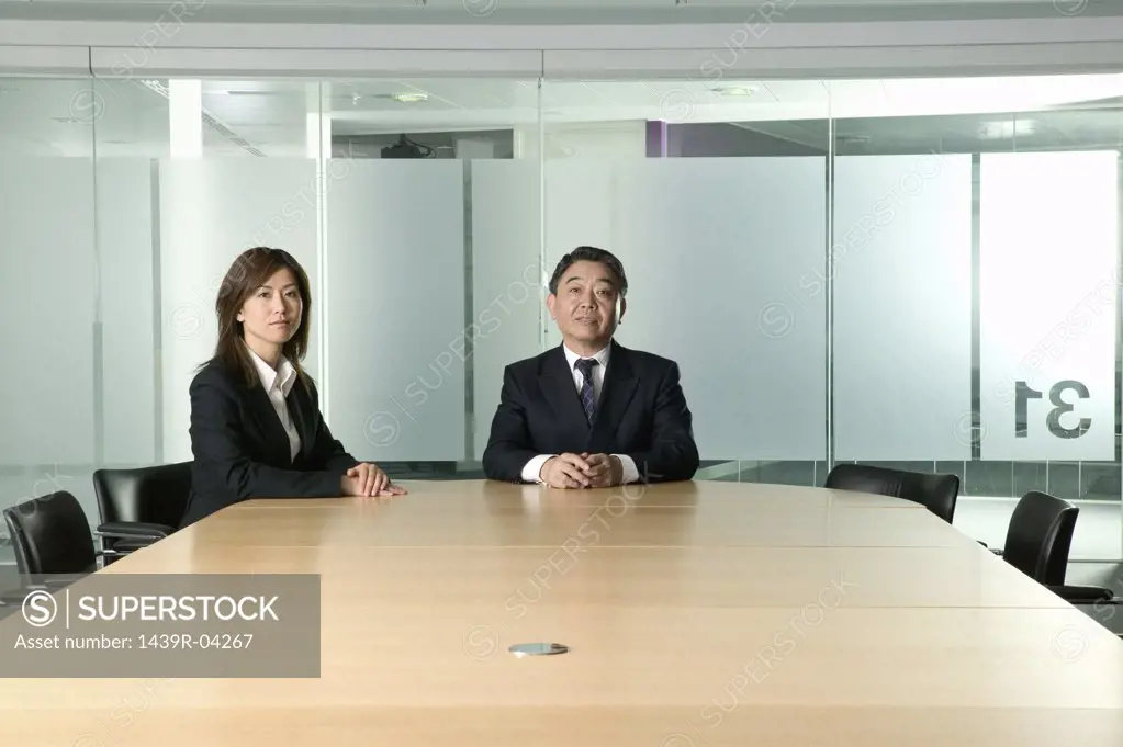Businessman and woman in conference room