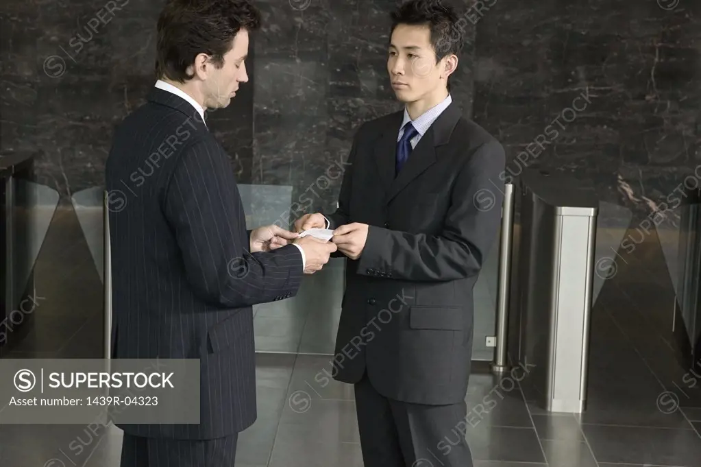 Businessmen exchanging business cards