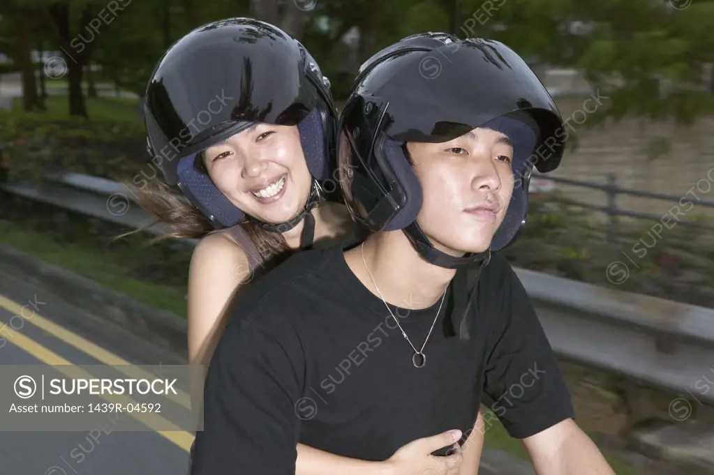 Young asian couple on moped