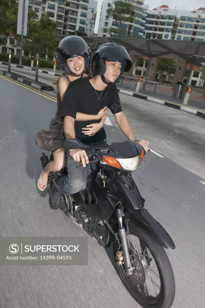 Young asian couple on moped