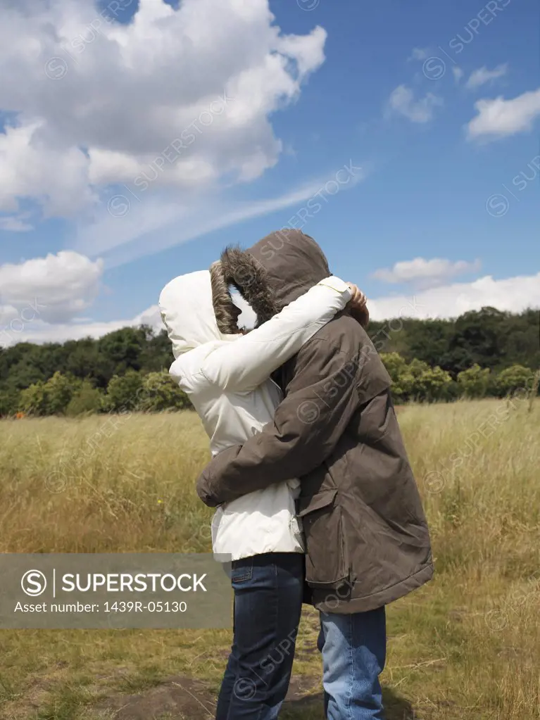Couple in parkas hugging
