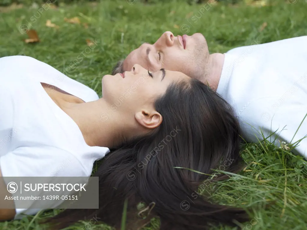 Young couple relaxing in field