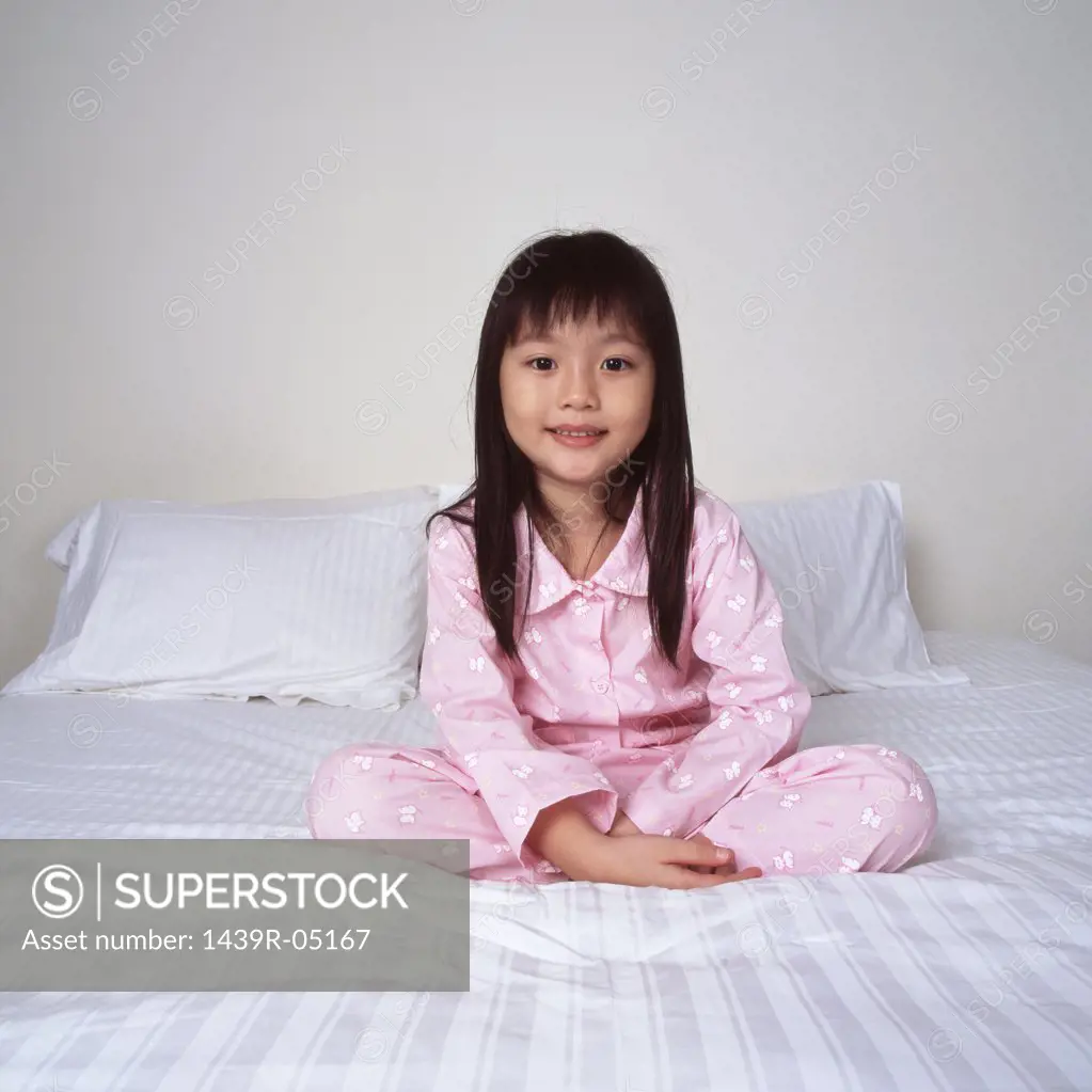 Smiling young girl on bed