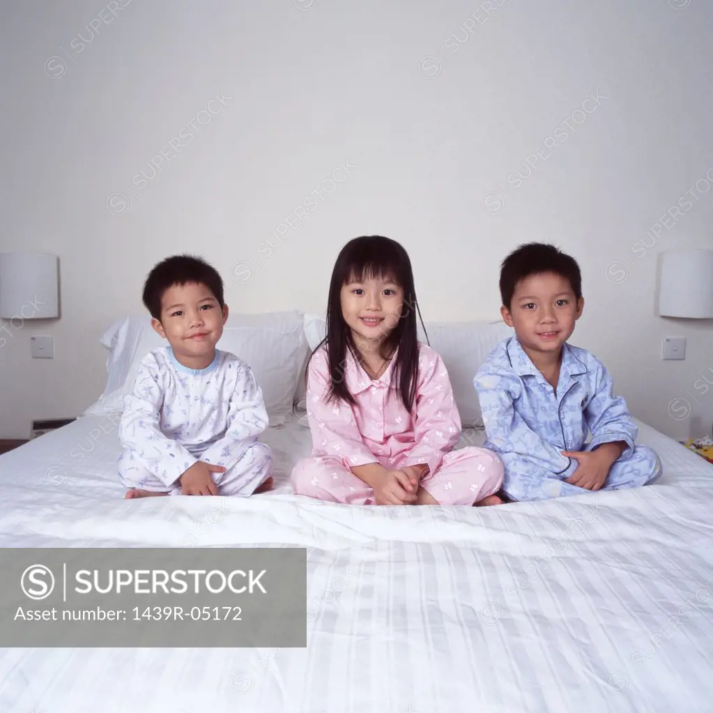 Children on bed smiling