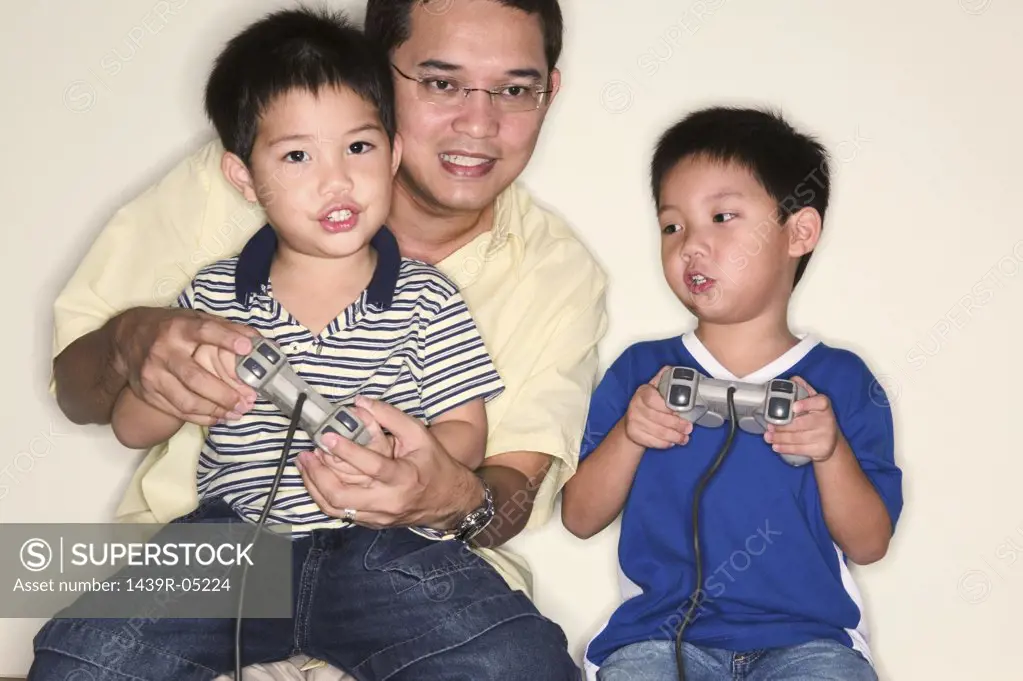 Father and sons playing video game