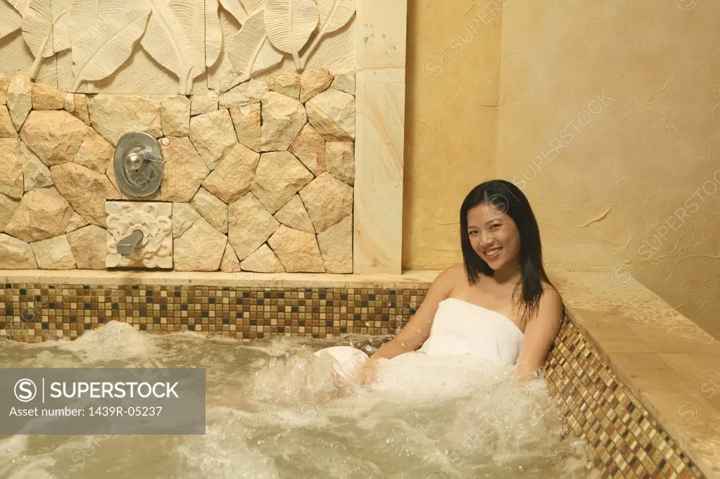 Smiling woman in hot tub