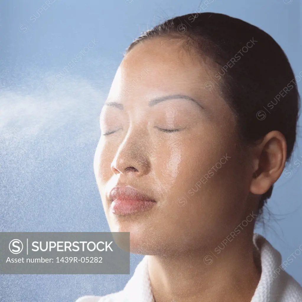Water spraying on womans face