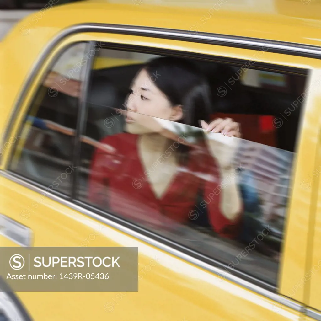 Woman looking out of taxicab window