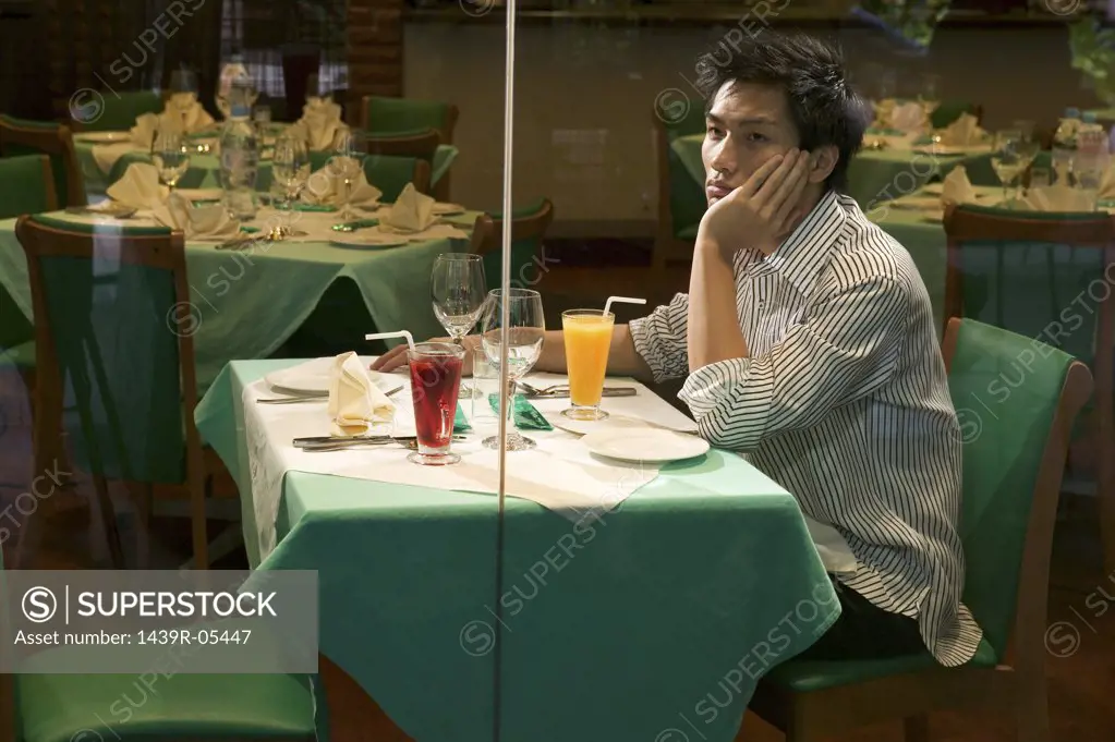 Young man waiting in restaurant