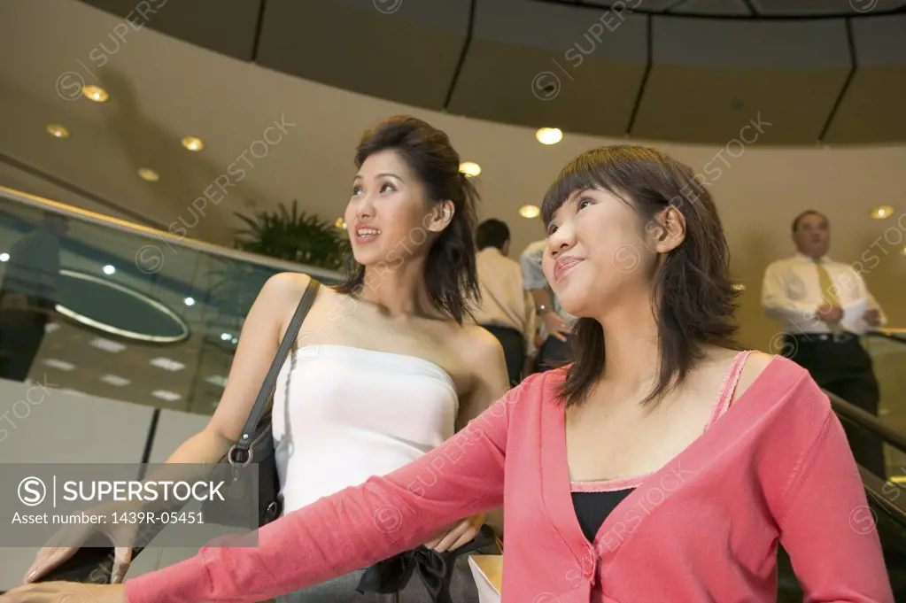 Young women on escalator