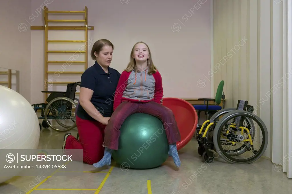 Girl exercising on fitness ball
