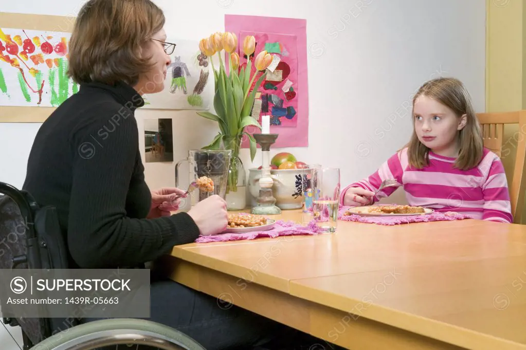 Mother and daughter eating beans on toast