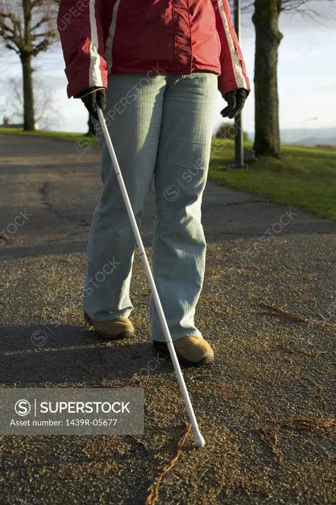 Blind woman using a cane