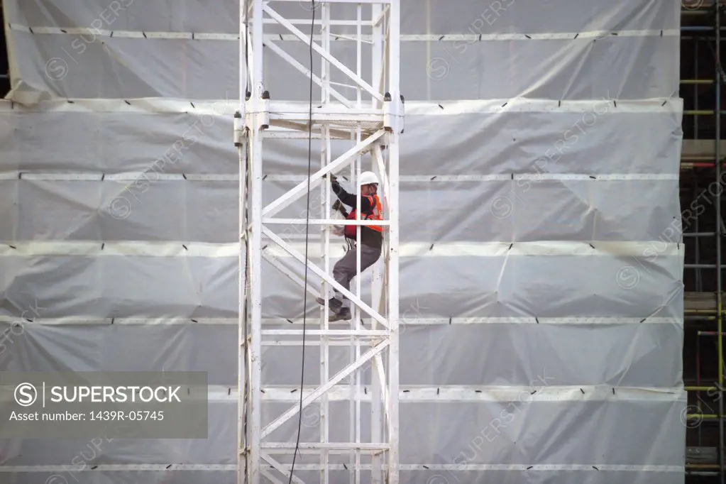 Worker on crane at site