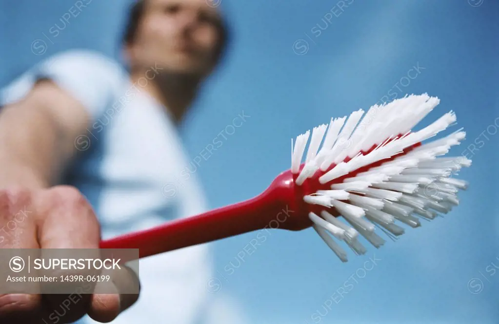 Man holding scrubbing brush