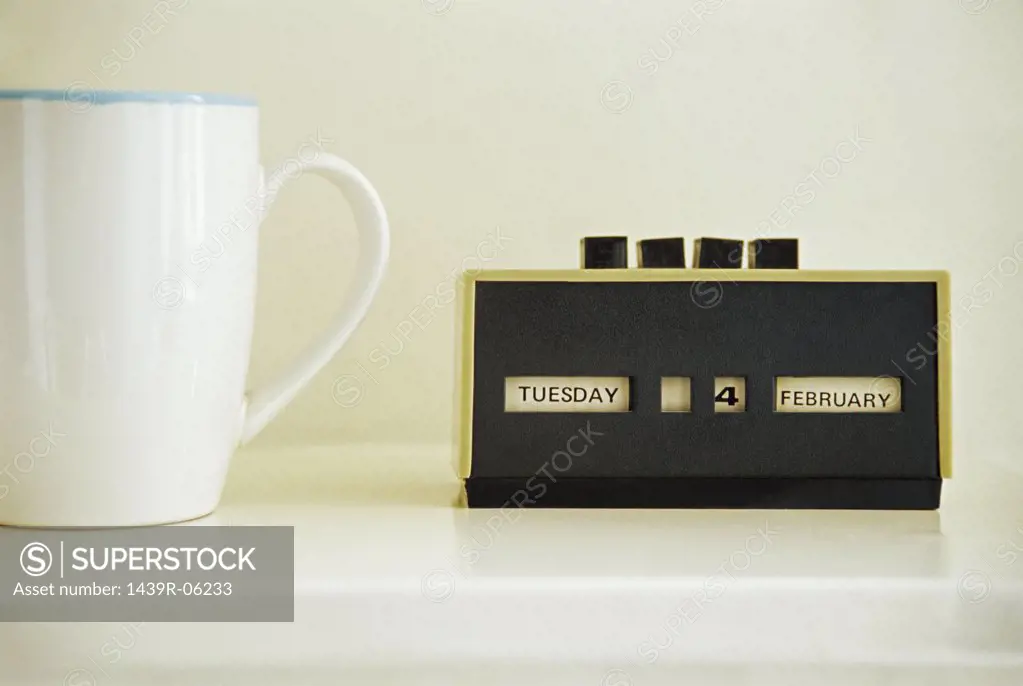 Coffee cup and retro calendar