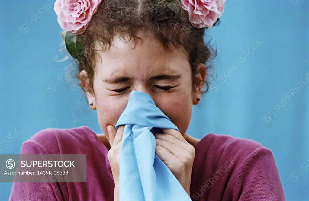 Girl blowing her nose