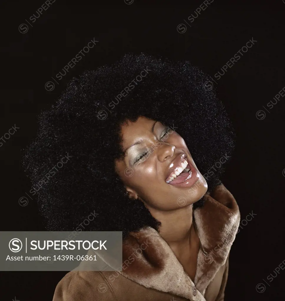 Woman in fur coat laughing