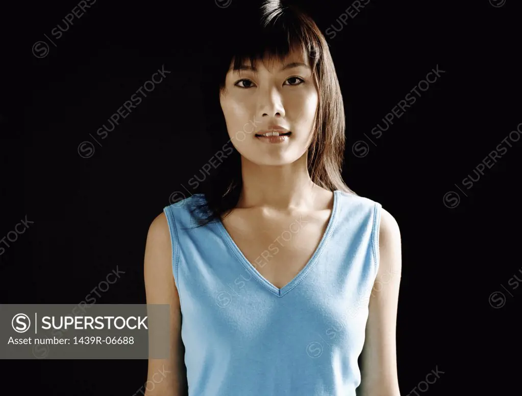 Young asian woman in blue vest