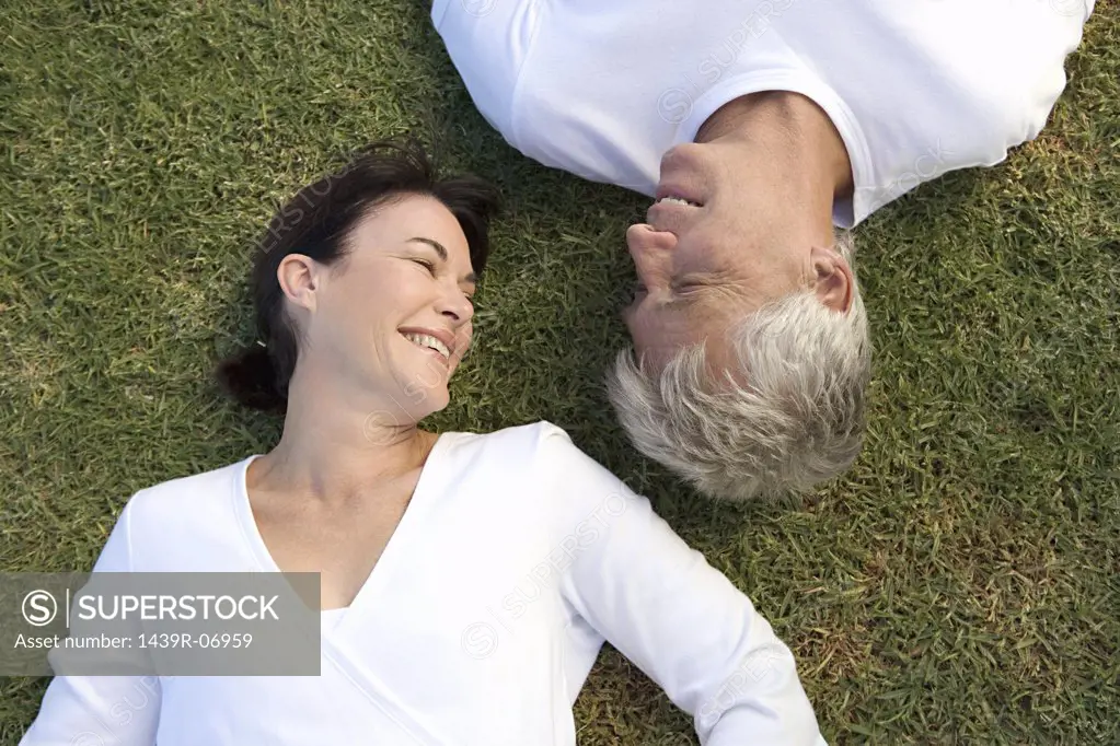 Mature couple lying on the grass