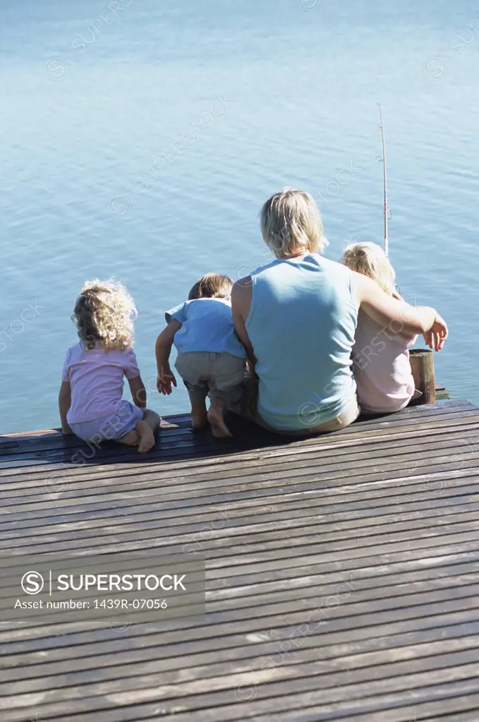 Father with children on a jetty