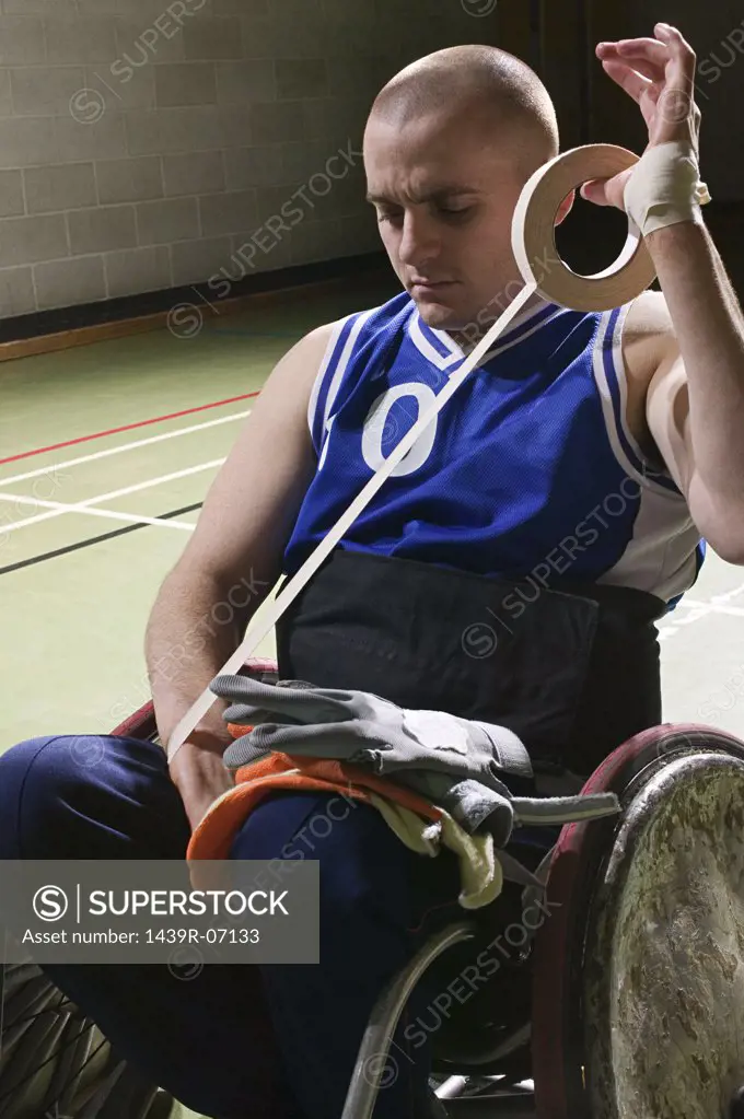 Basketball player bandaging his arm