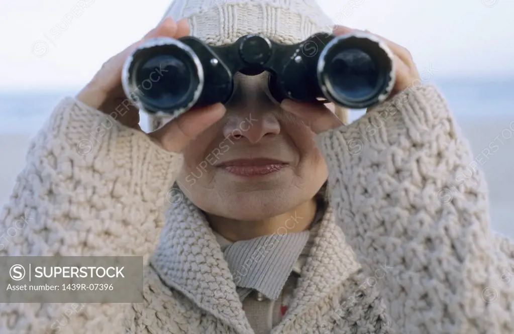 Senior woman using binoculars