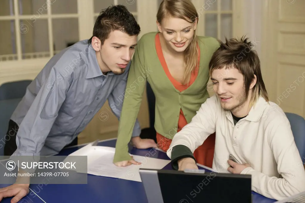 Colleagues looking at computer