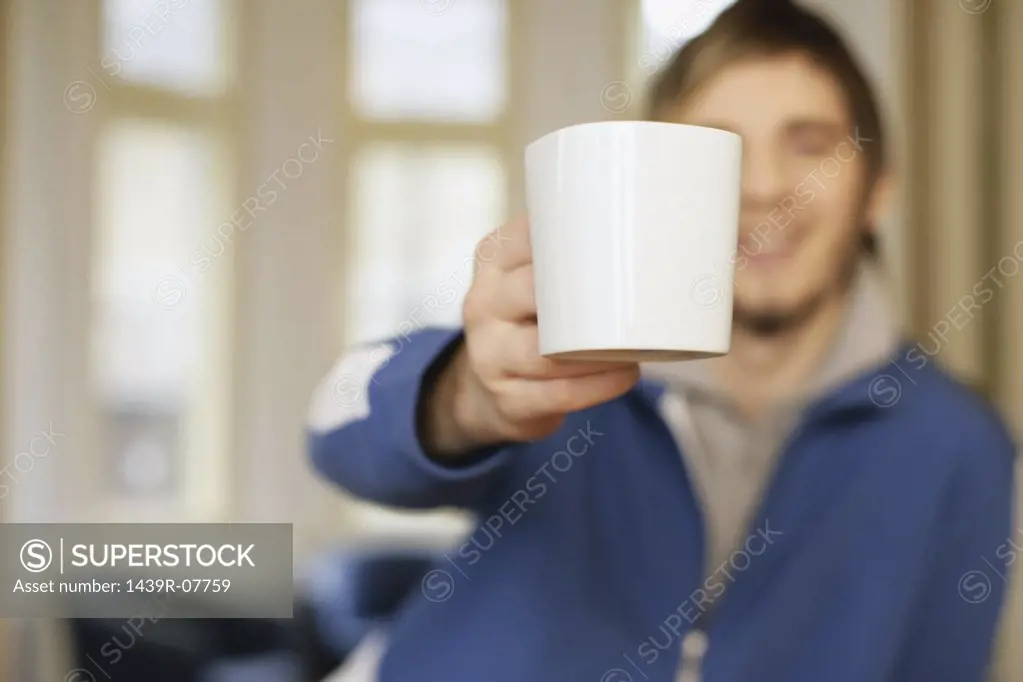 Man offering coffee cup