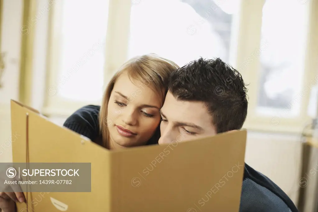 Man and woman looking at folder