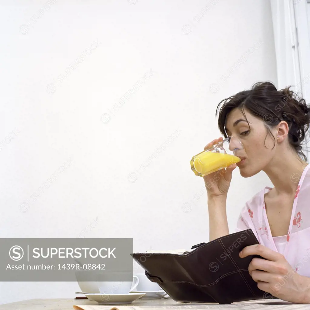 Woman with diary at breakfast