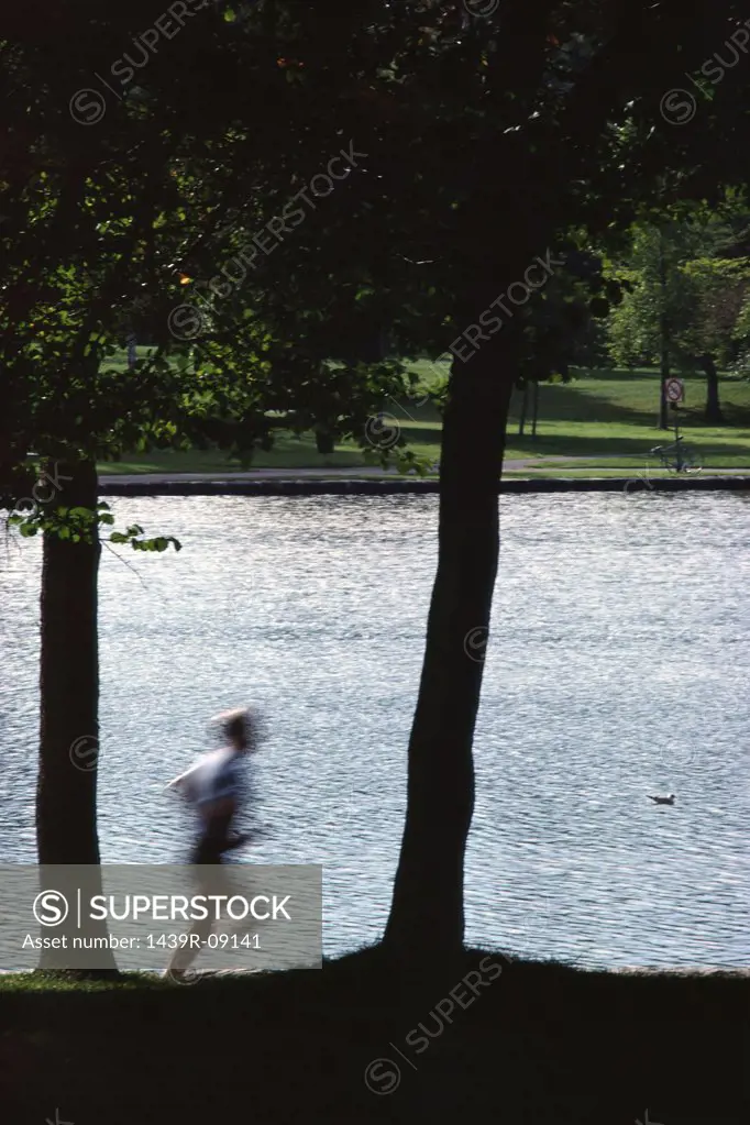 Blurred jogger in park