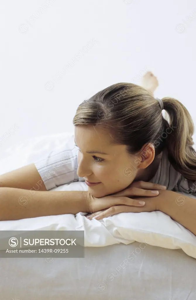Smiling woman relaxed on bed