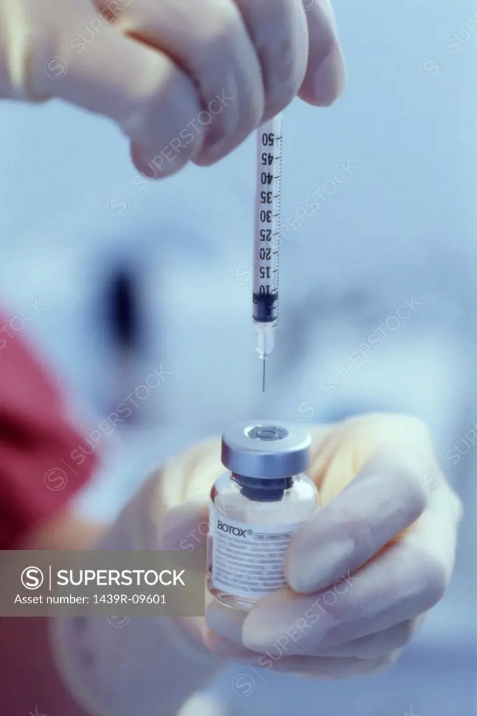 Anesthetist preparing for injection