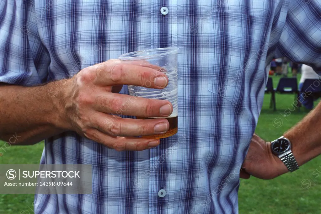Man drinking beer in garden