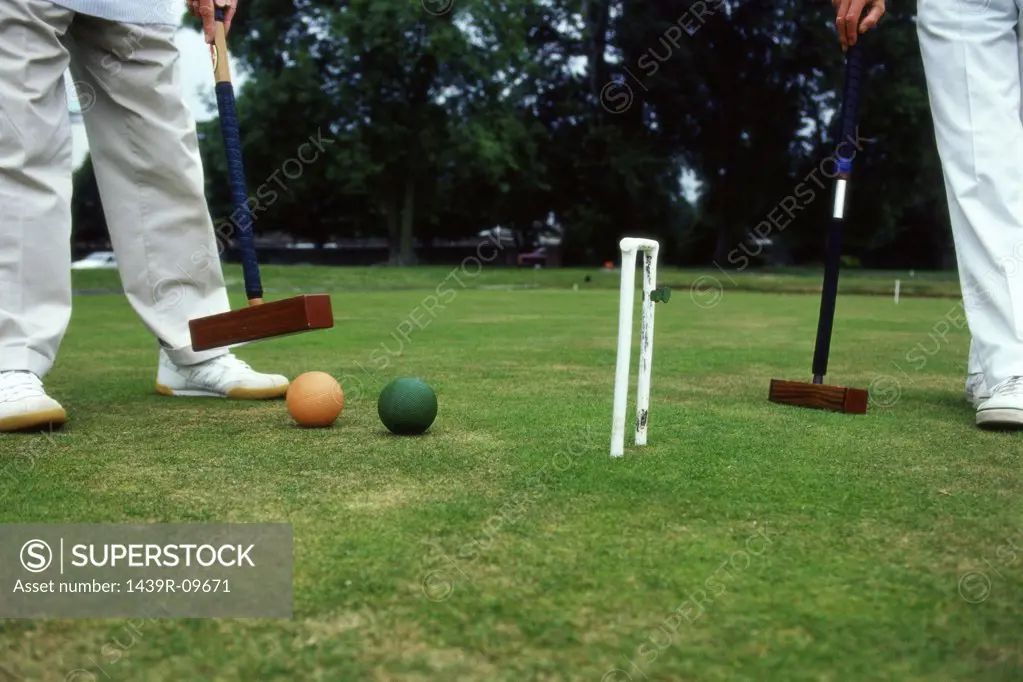Two men playing croquet