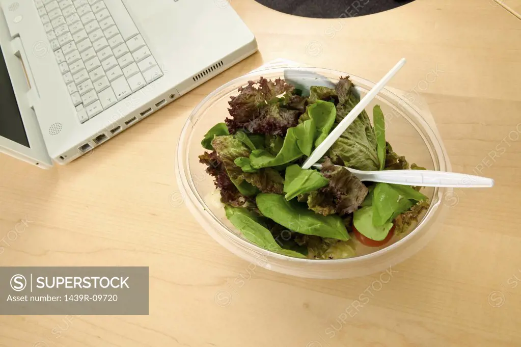 Bowl of salad on desk