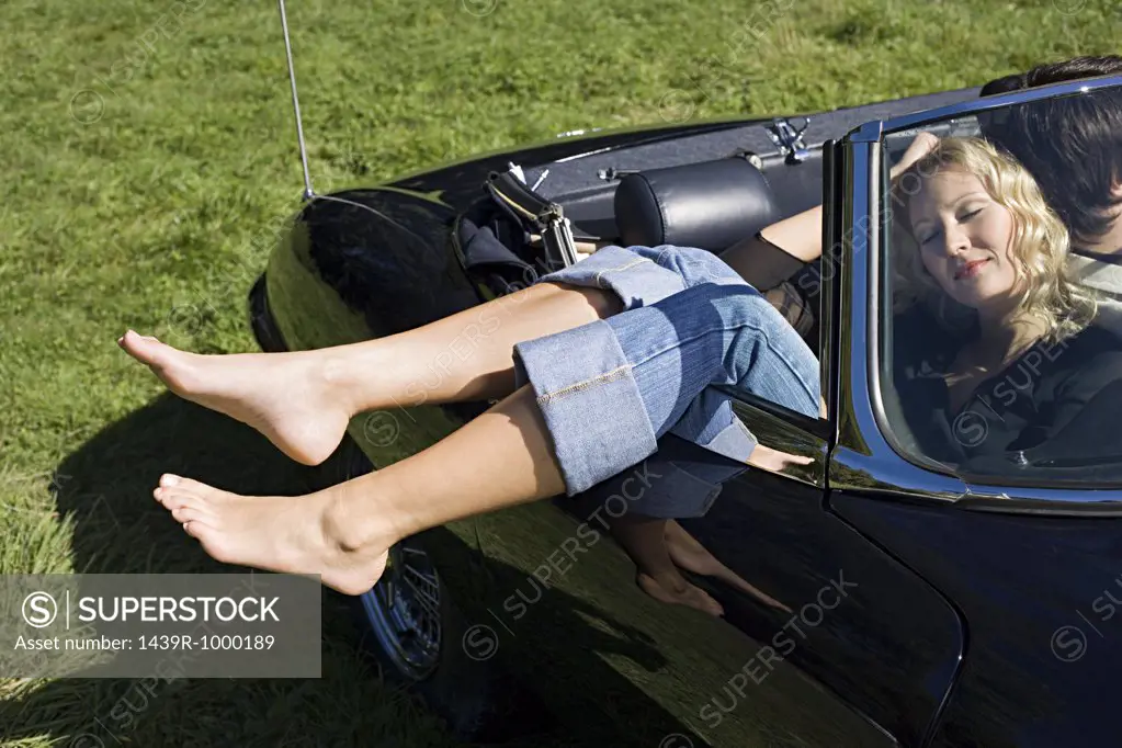 Couple sleeping in a convertible