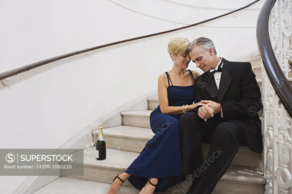 Glamorous couple on flight of stairs