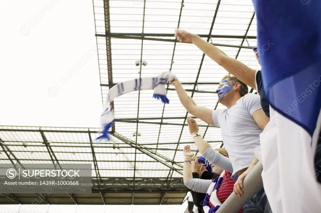 Football crowd waving scarves
