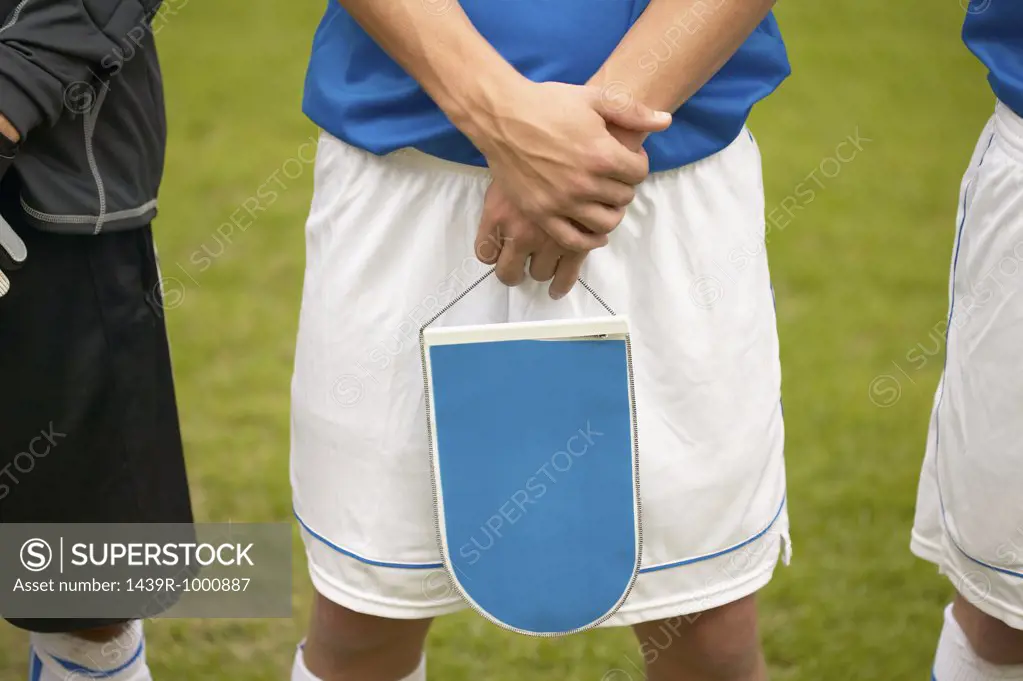 Footballer holding shield