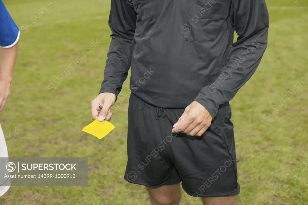 Referee giving yellow card
