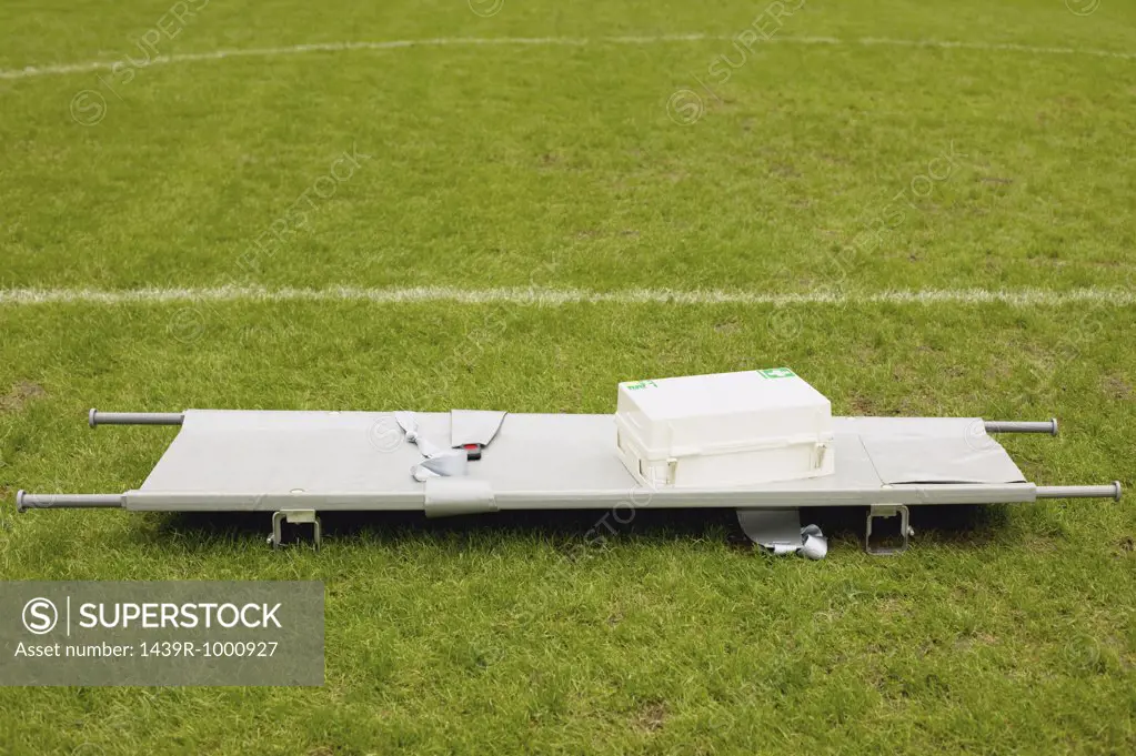 Stretcher and first aid on football pitch