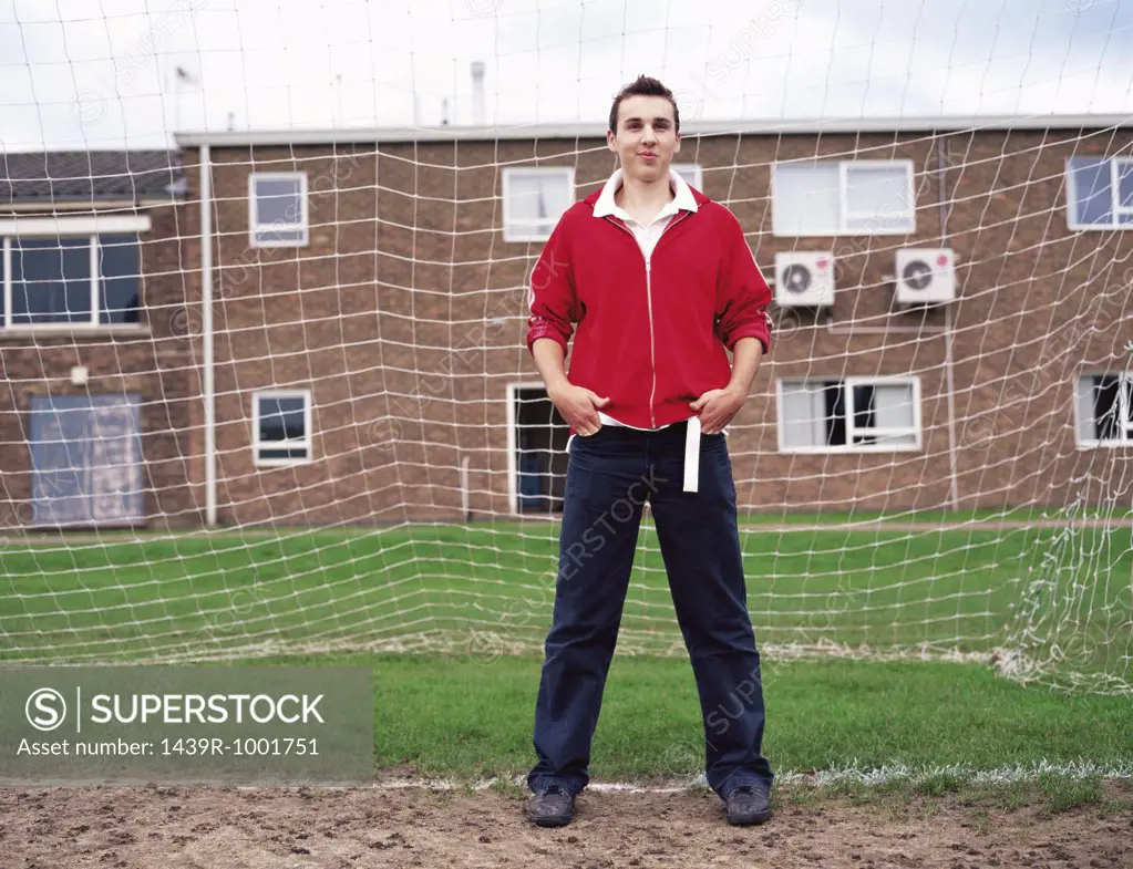 Teenage boy standing in goal