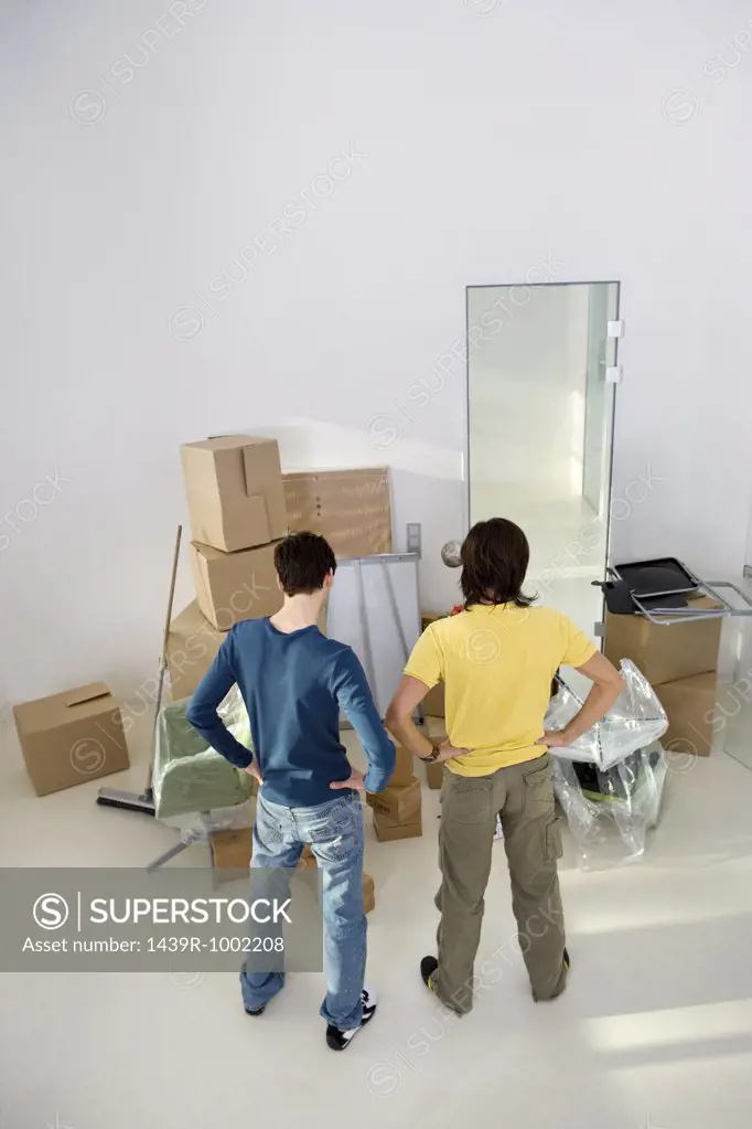 Young men looking at cardboard boxes