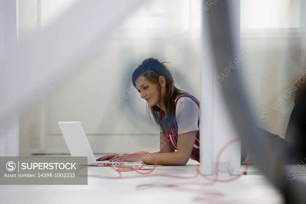 Woman with laptop on floor