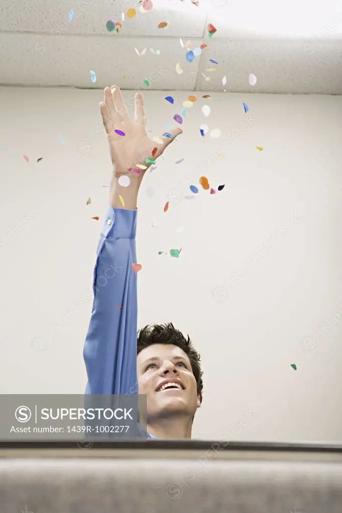 Businessman throwing confetti