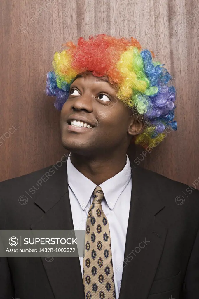 Businessman wearing clowns wig