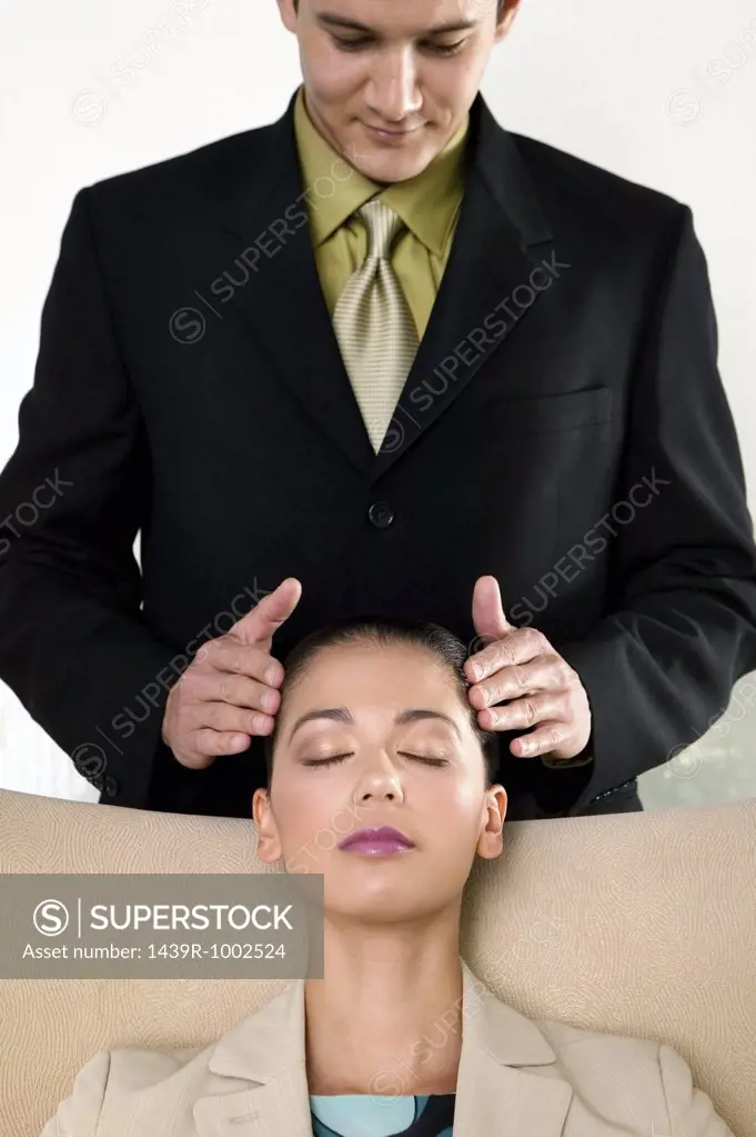 Businessman massaging businesswoman