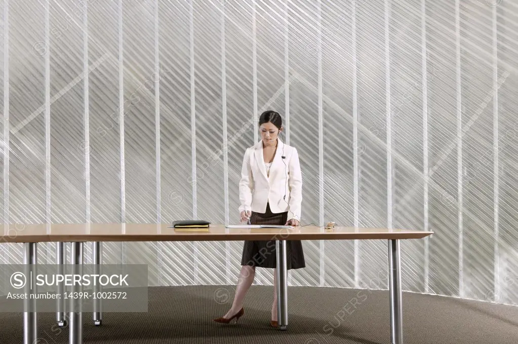 Businesswoman standing by table